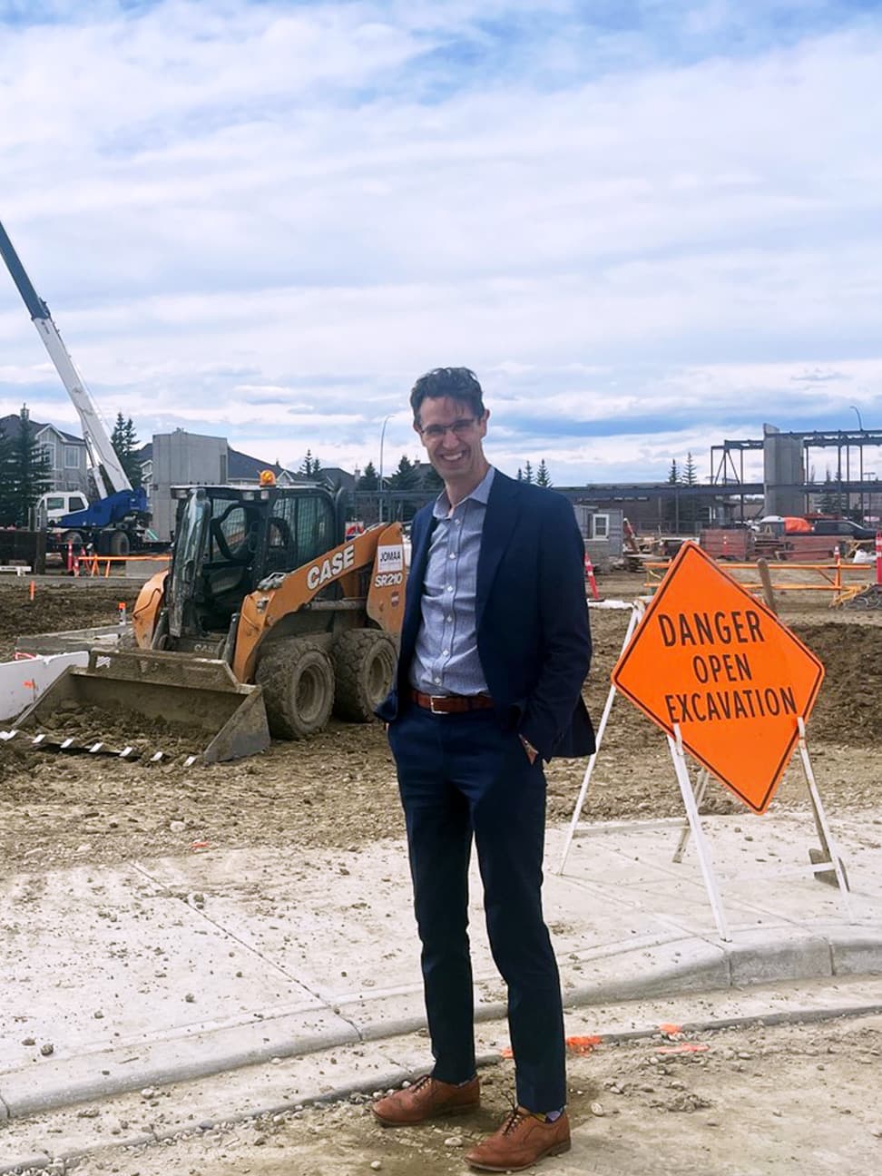 Alistair Corbett standing in front of construction site