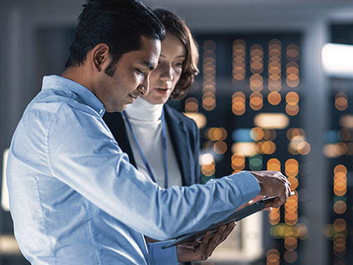 IT professionals reviewing content on a tablet