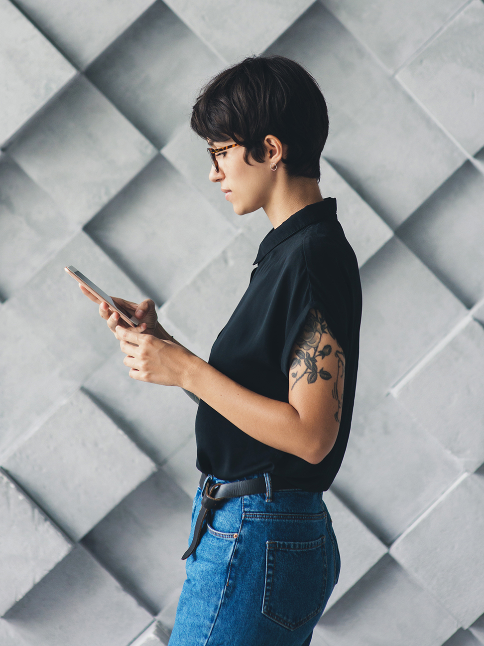Female walking and looking at mobile phone