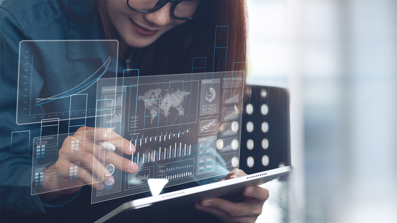 A person looking a tablet with virtual dashboards
