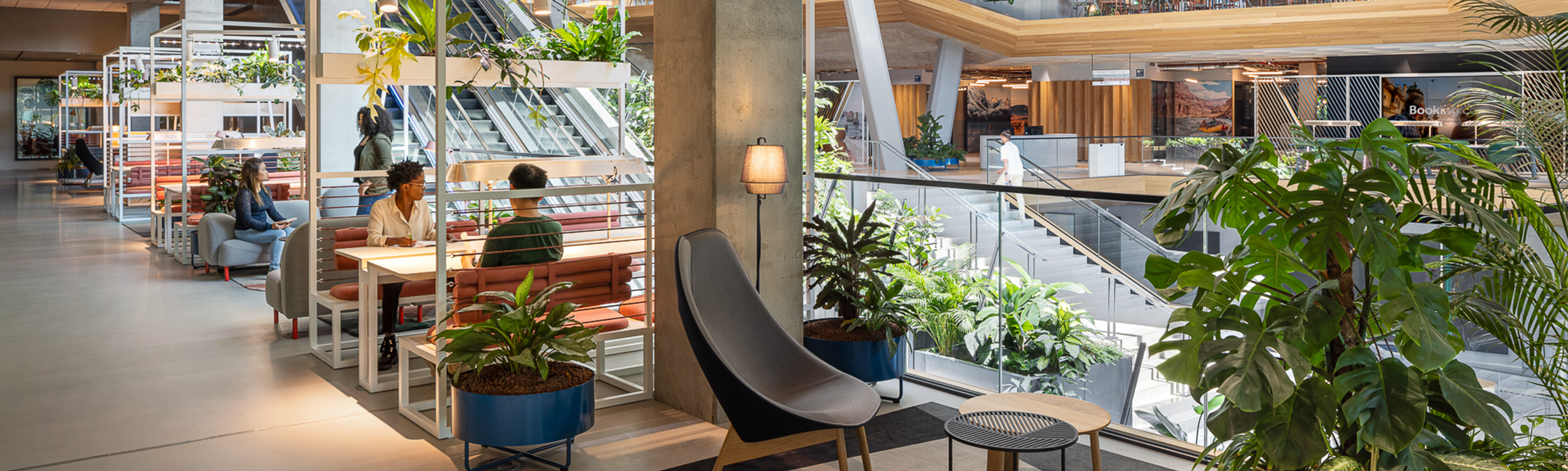 employees sit in interior of office atrium