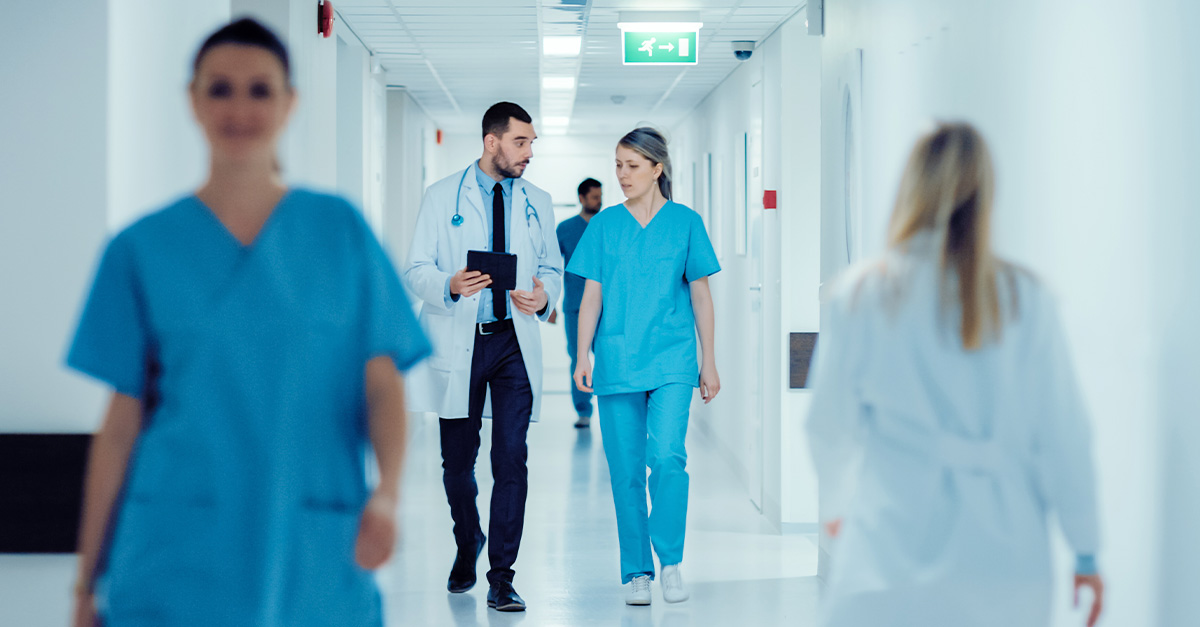 Doctors talking in a hallway.
