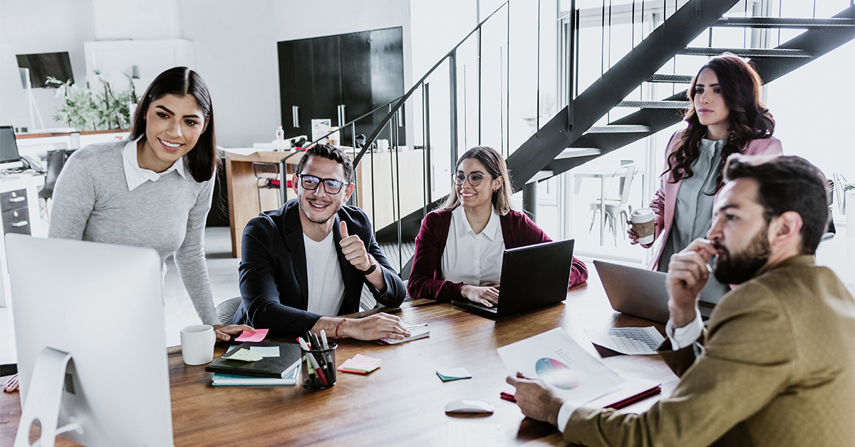 People collaborating around a desk.
