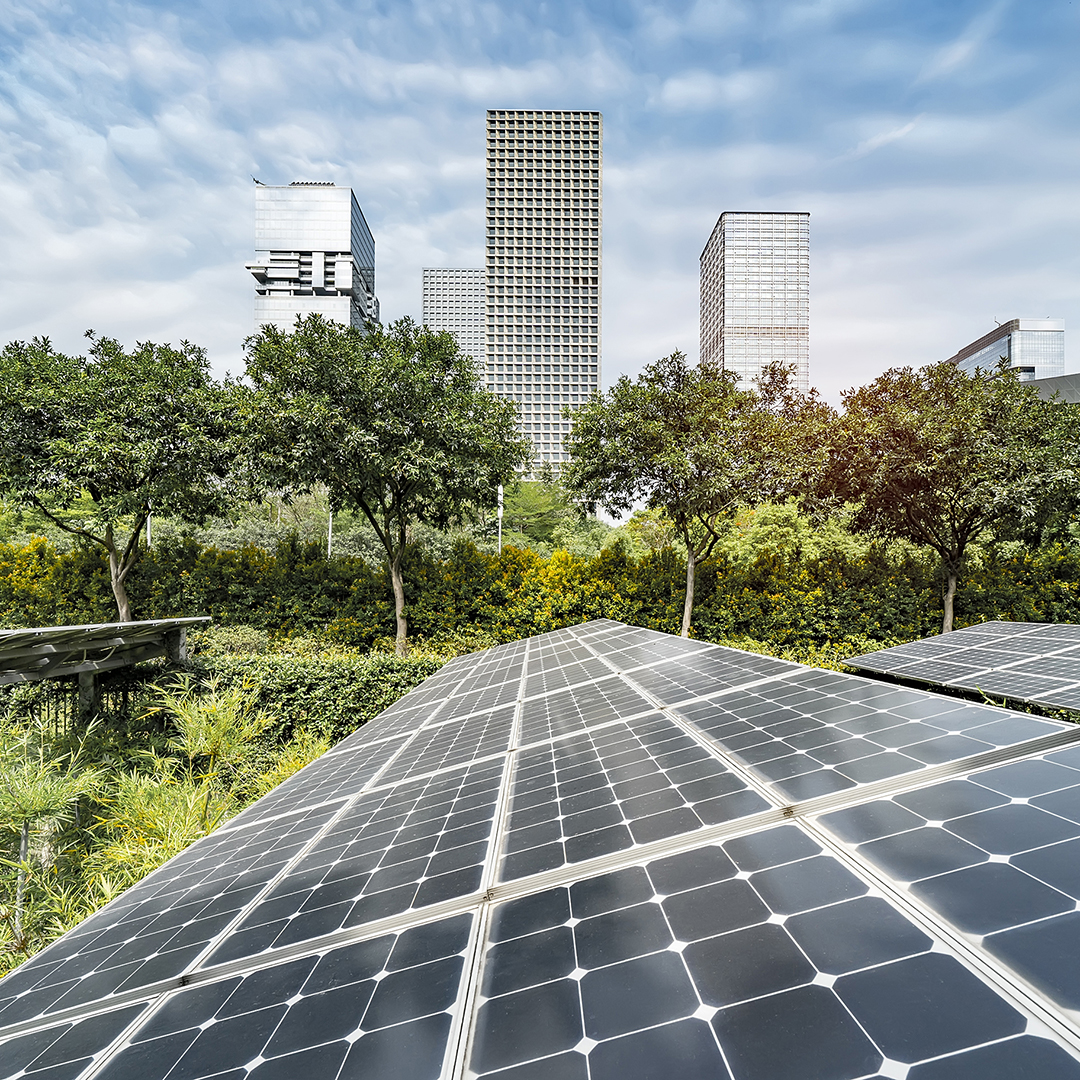 Solar panels with city skyscrapers in background