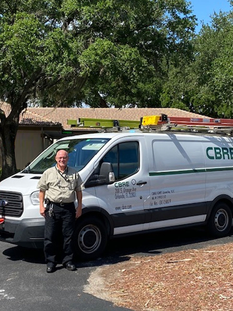 Randy standing next to CBRE van