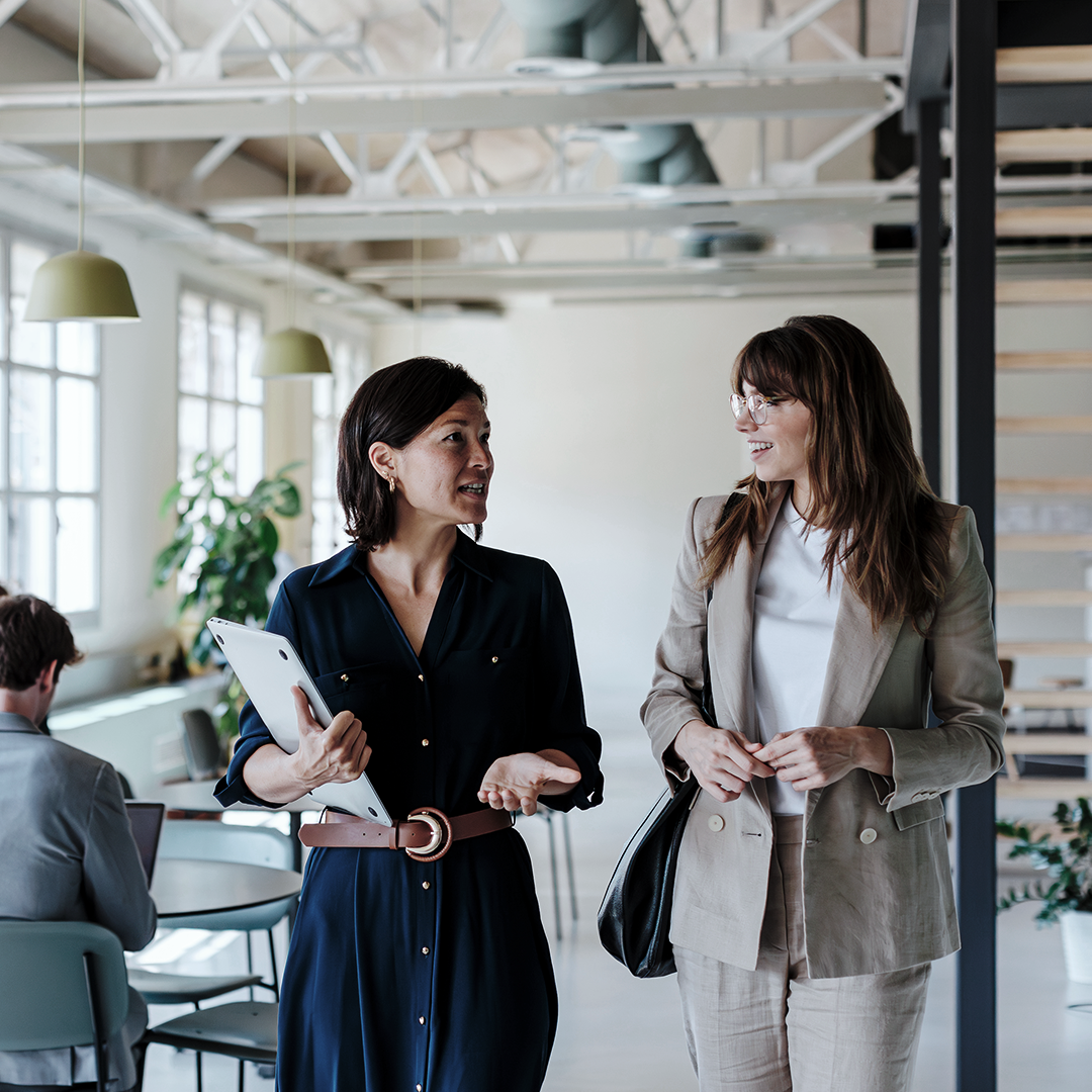 Two coworkers walking and talking together
