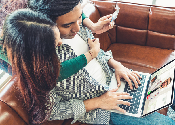 couple consults with their doctor on video conference