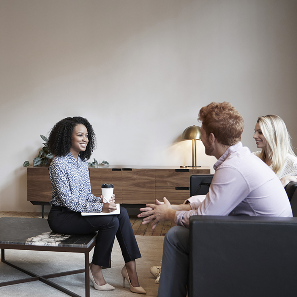 Colleagues talking in an informal office setting