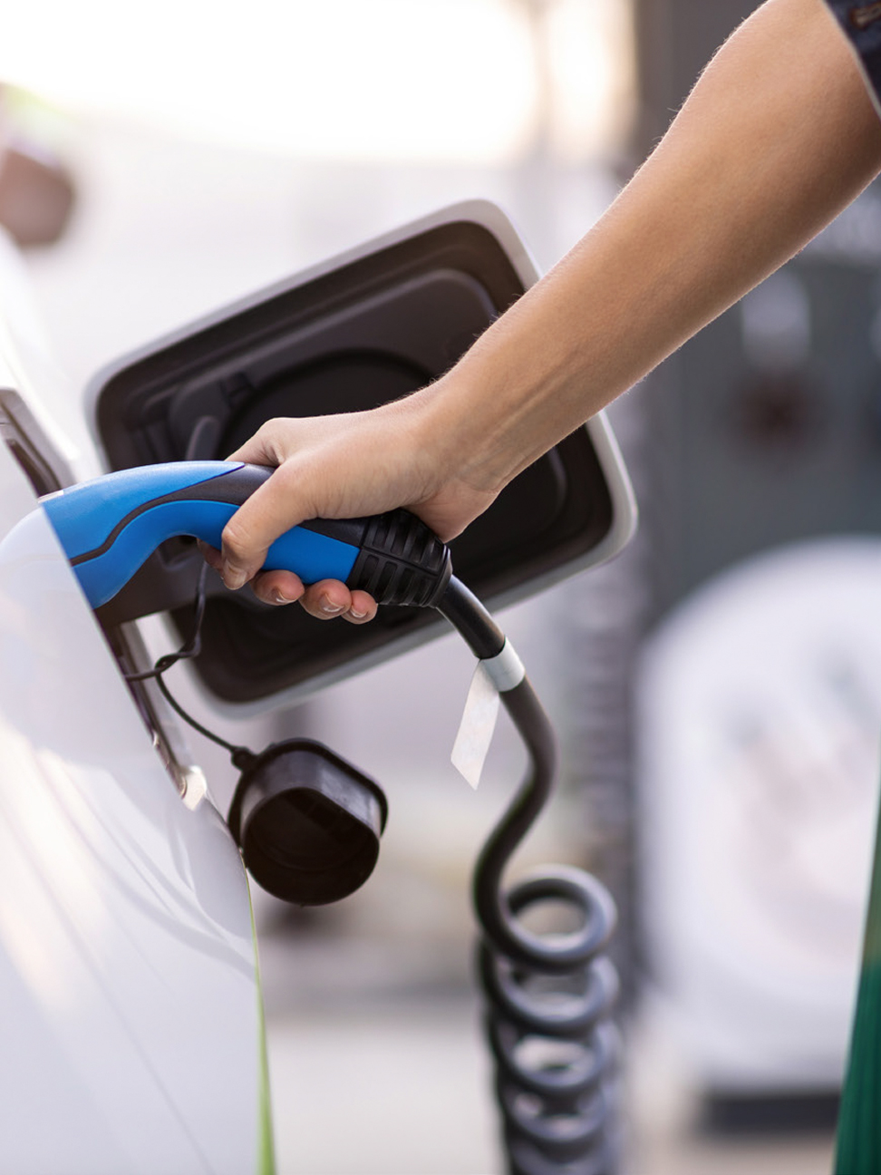 plugging in charger into electric vehicle