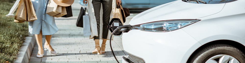 shoppers returning to their electric vehicle after shopping