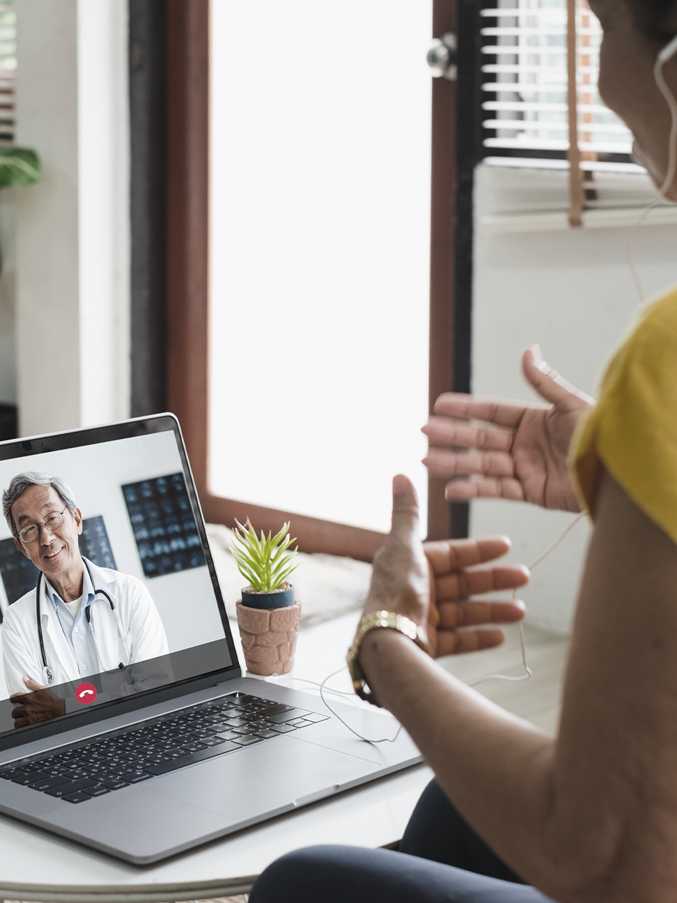 Person using a laptop for telehealth appointment