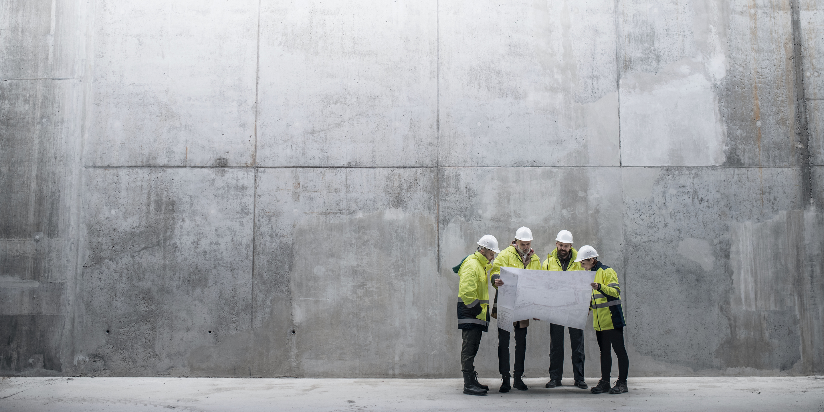 Construction Workers In Front Of Wall