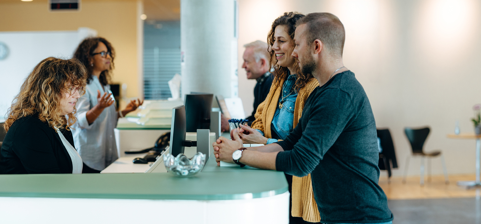 Image of people at office reception desk