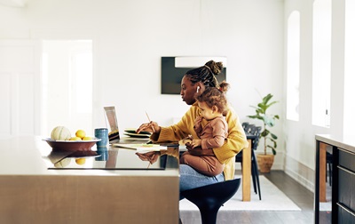 Image of woman and child at a desk