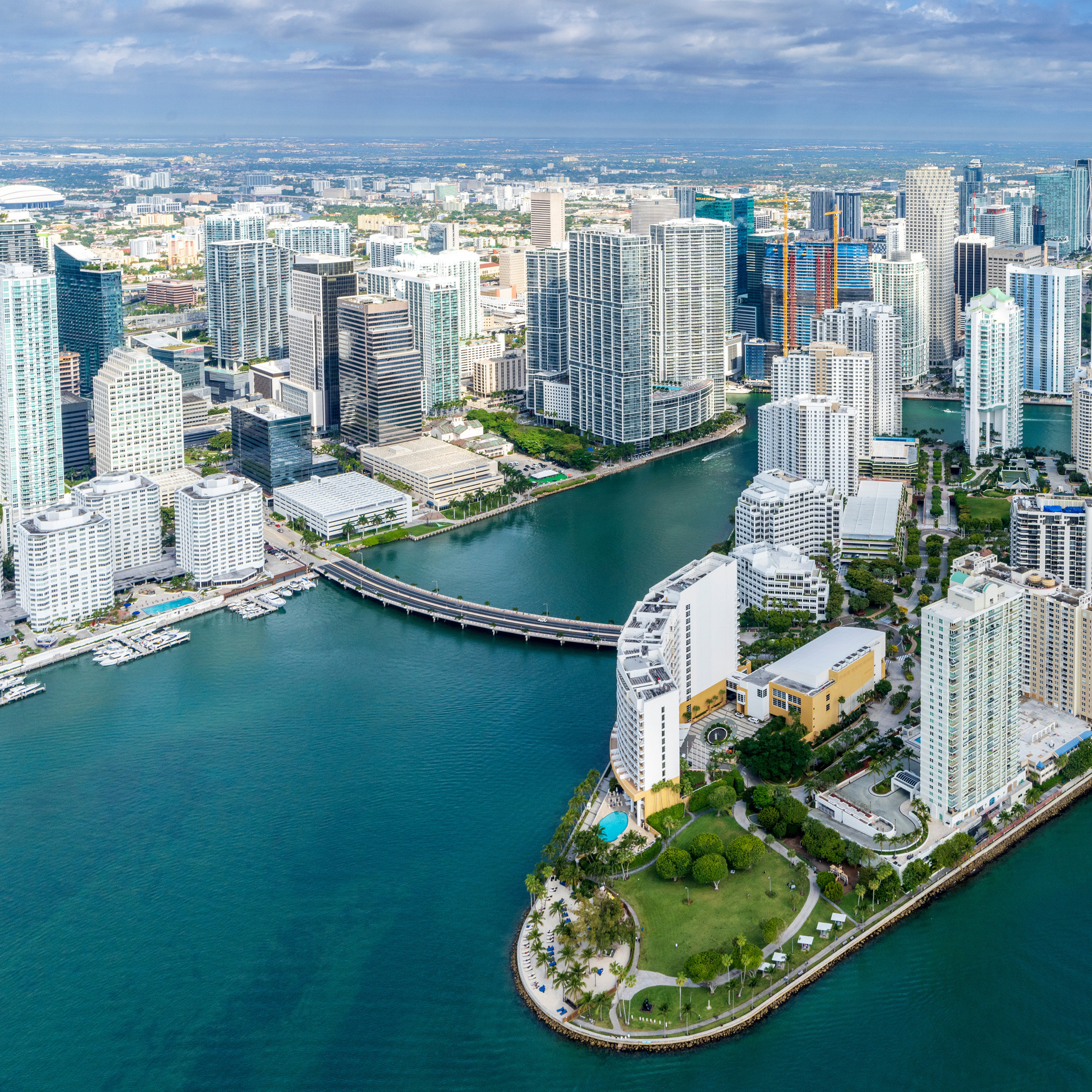 Aerial view of Miami's downtown skyline, featuring high-rise buildings, waterfront property, and a lush green park. Ideal location for commercial real estate.