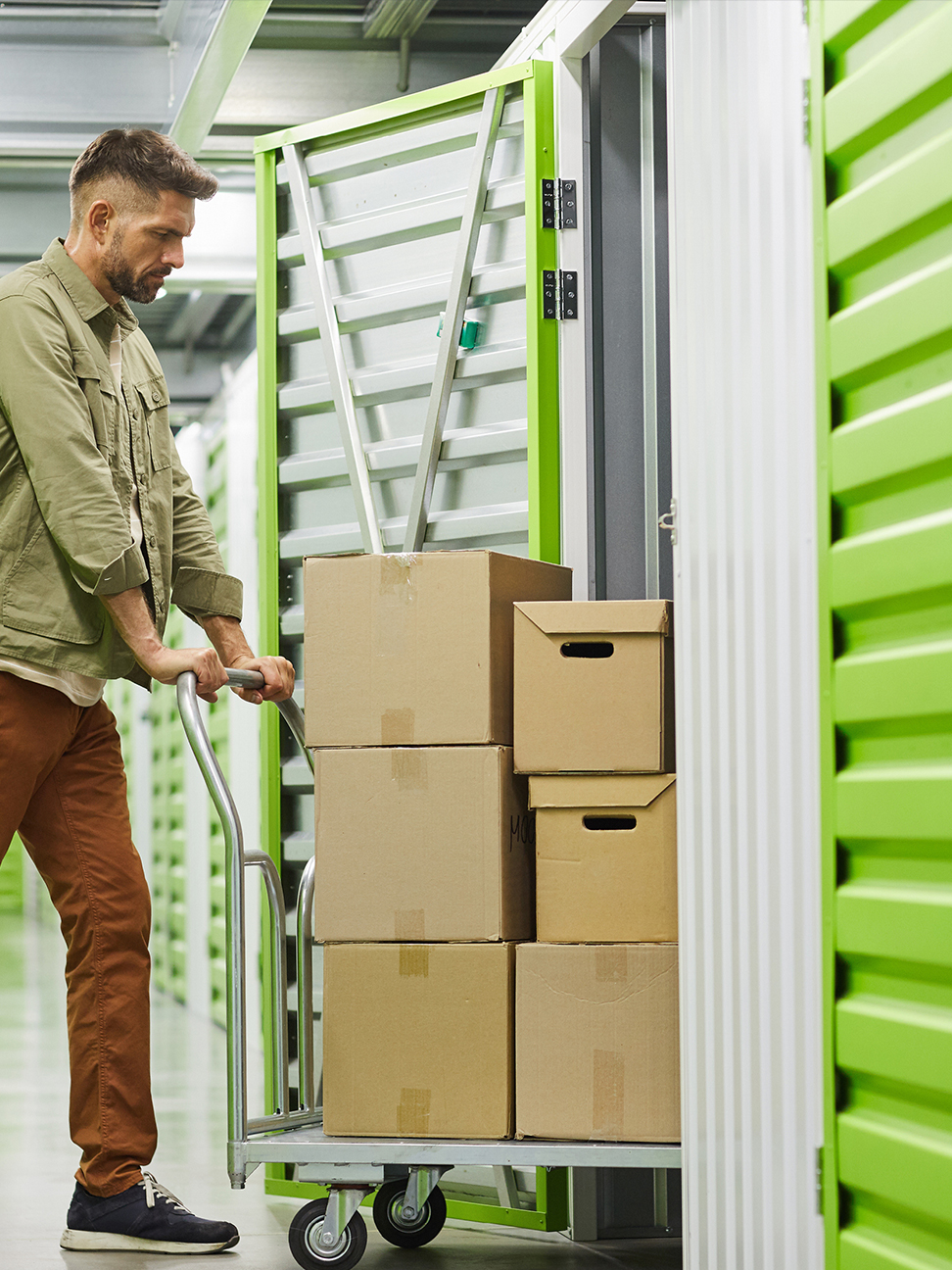 Man loading boxes into self storage unit