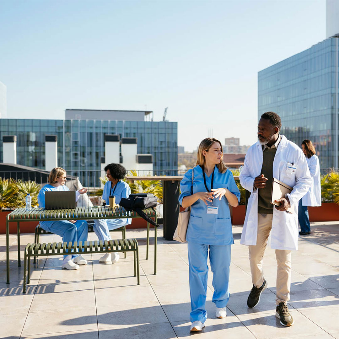 Medical professionals walking outside of hospital