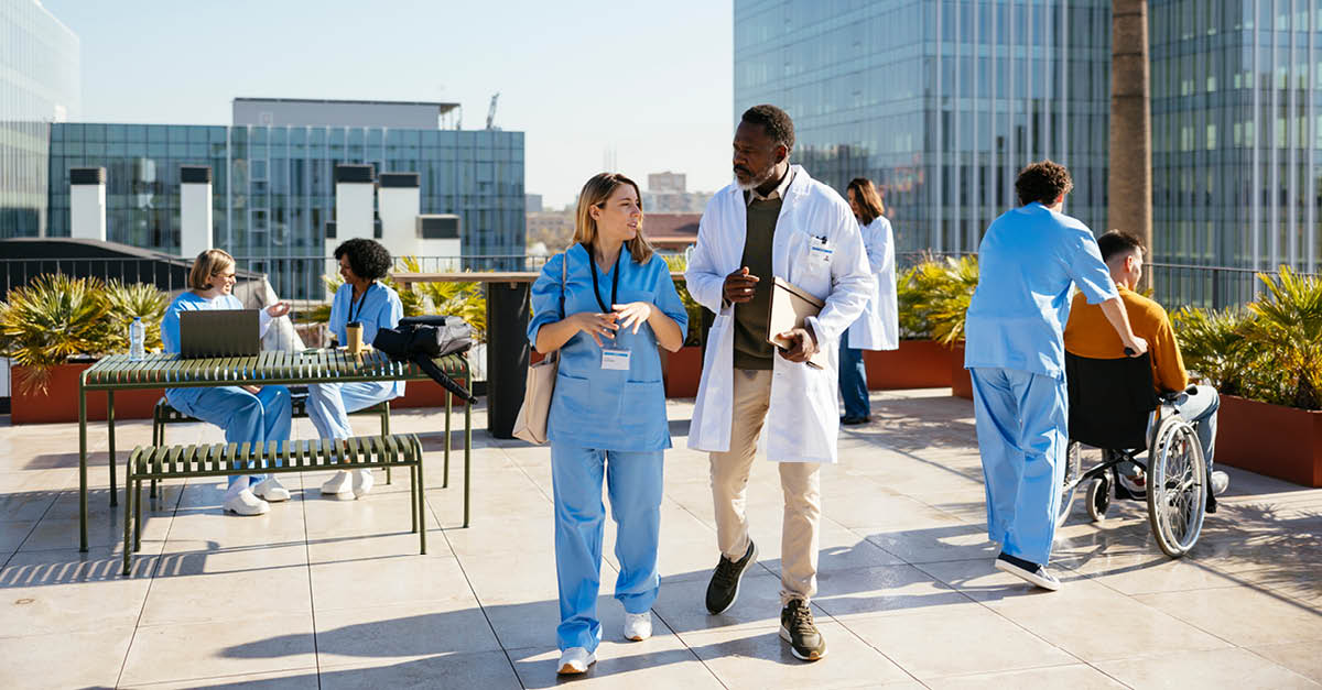 Medical professionals walking outside of hospital