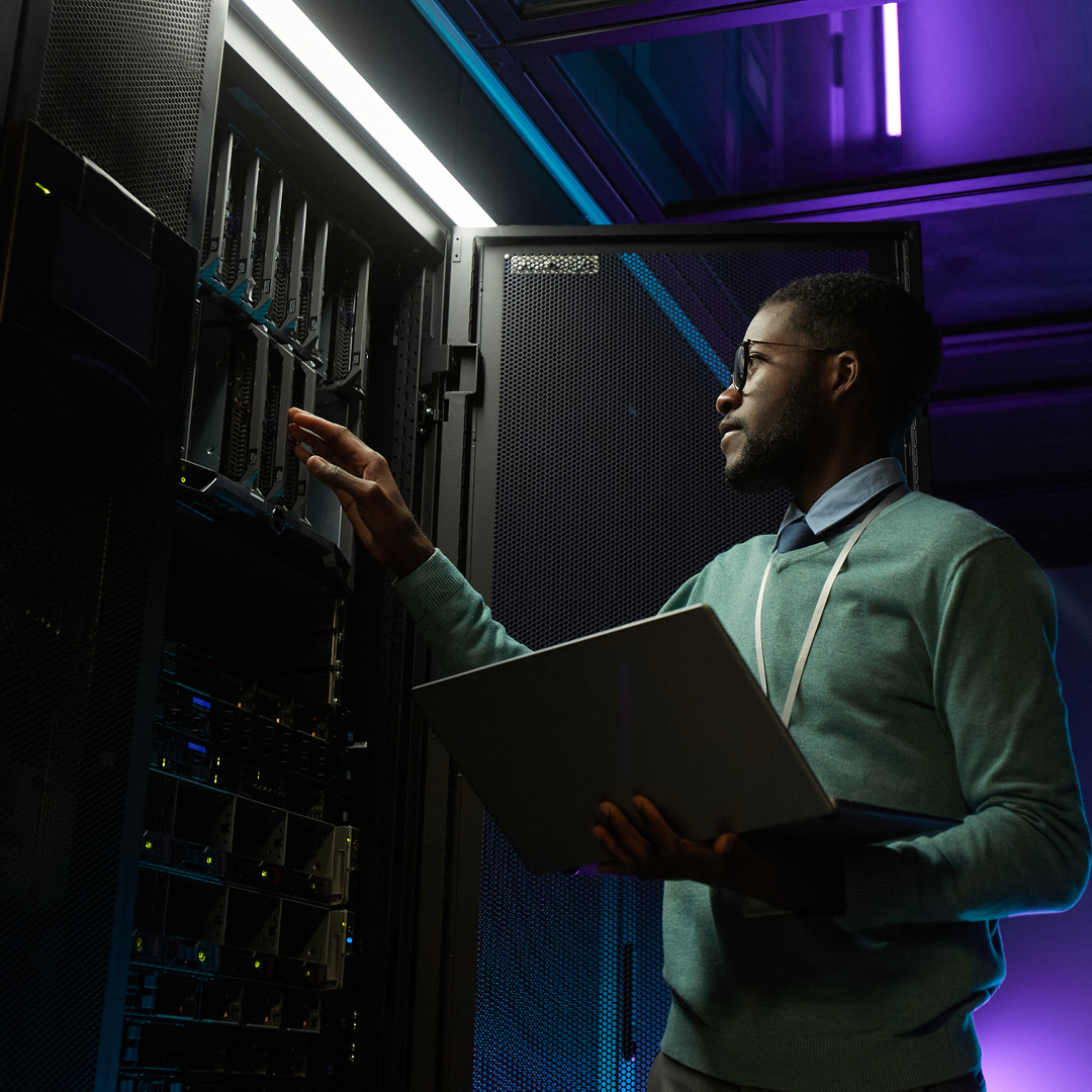 IT technician maintaining servers in a modern data center.