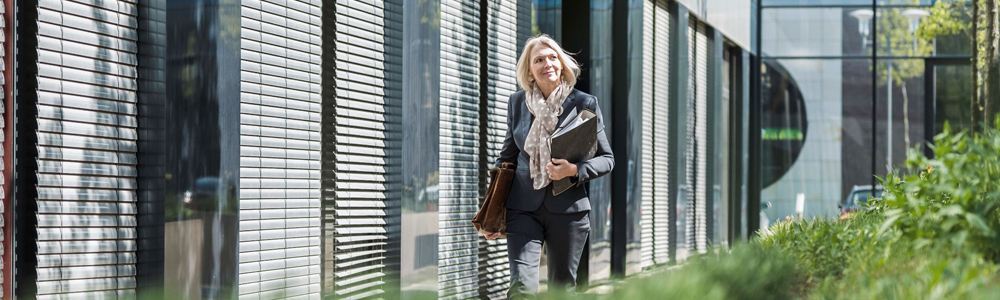 Image of woman walking in office patio