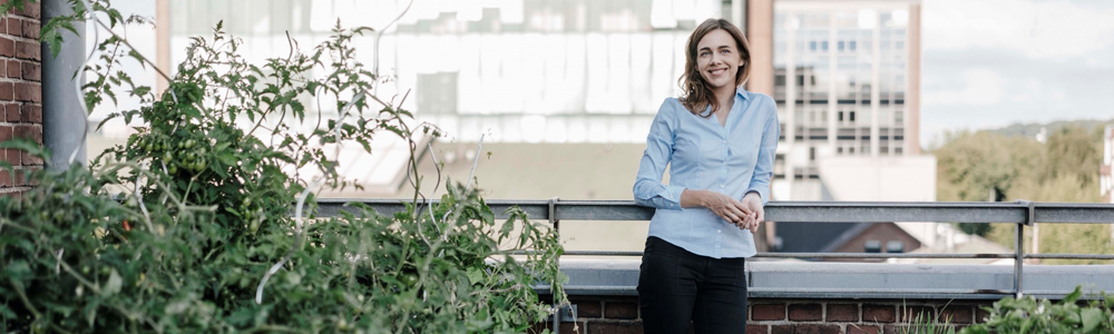 Image of woman on office patio with plants