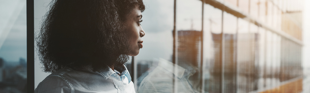 Woman in front of glass windows