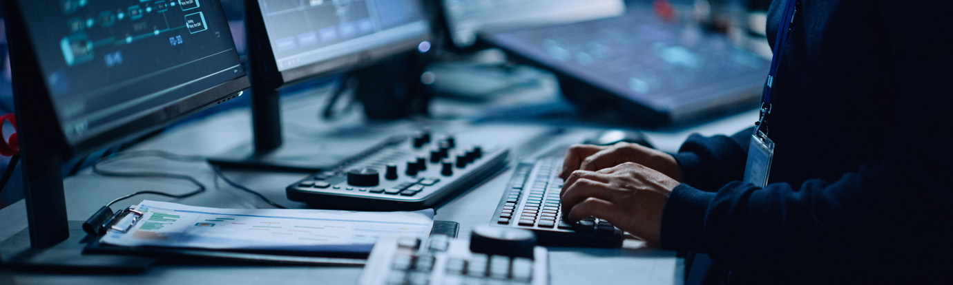 Data centre security sat at computer typing.