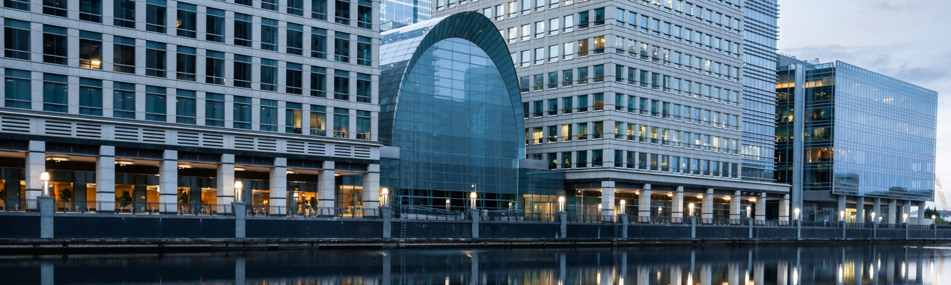Close-up of an office building behind river scenic.