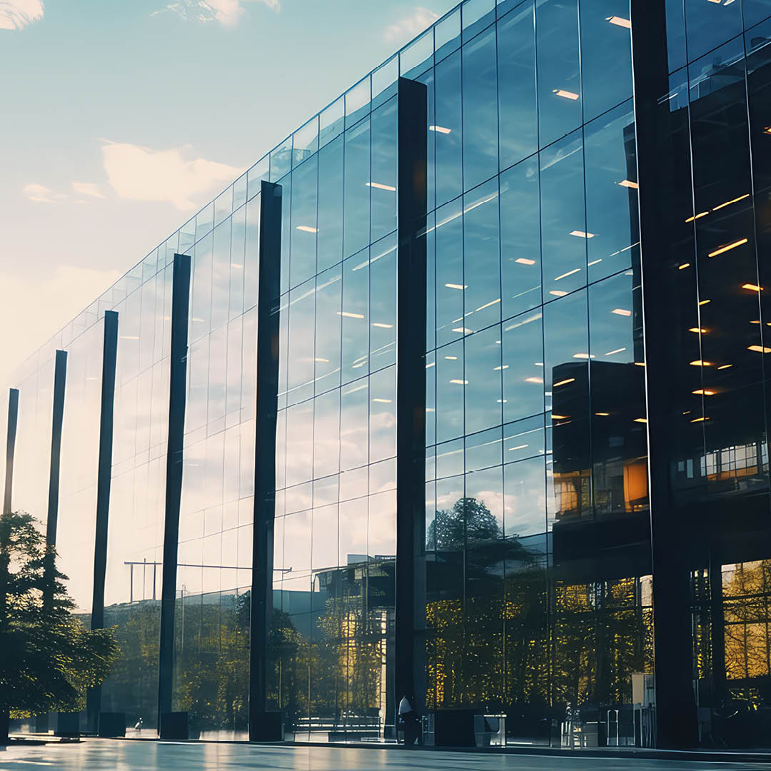Side view of glass building at sundown