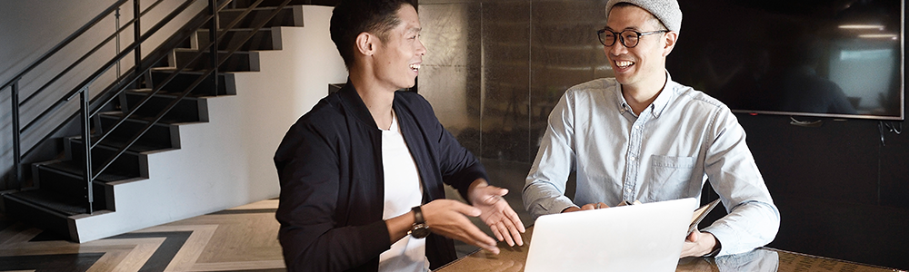 Image of men working at a desk