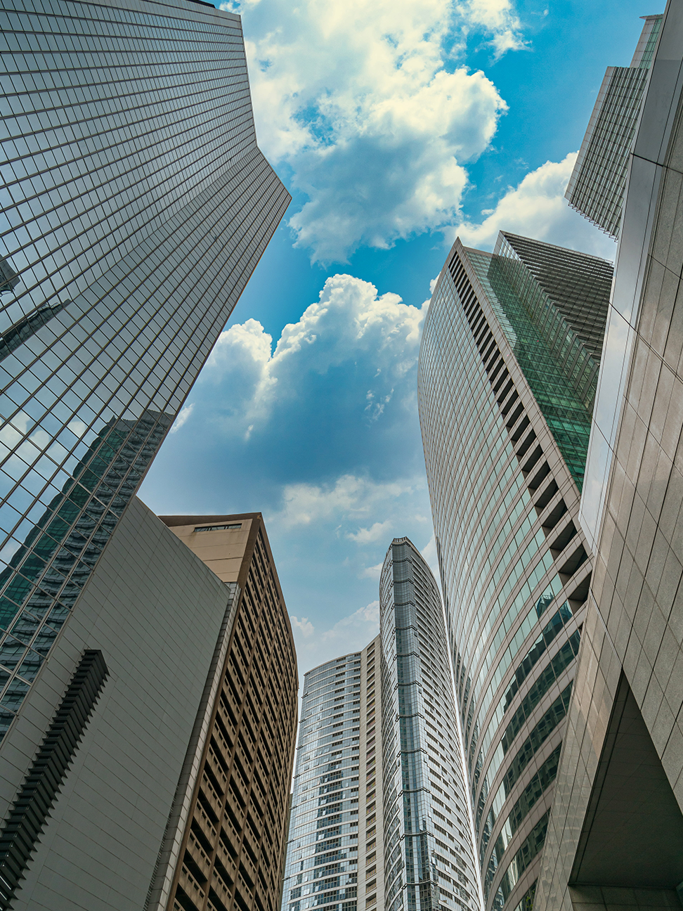 Vertical view of skyscrapers towering into the sky behind it
