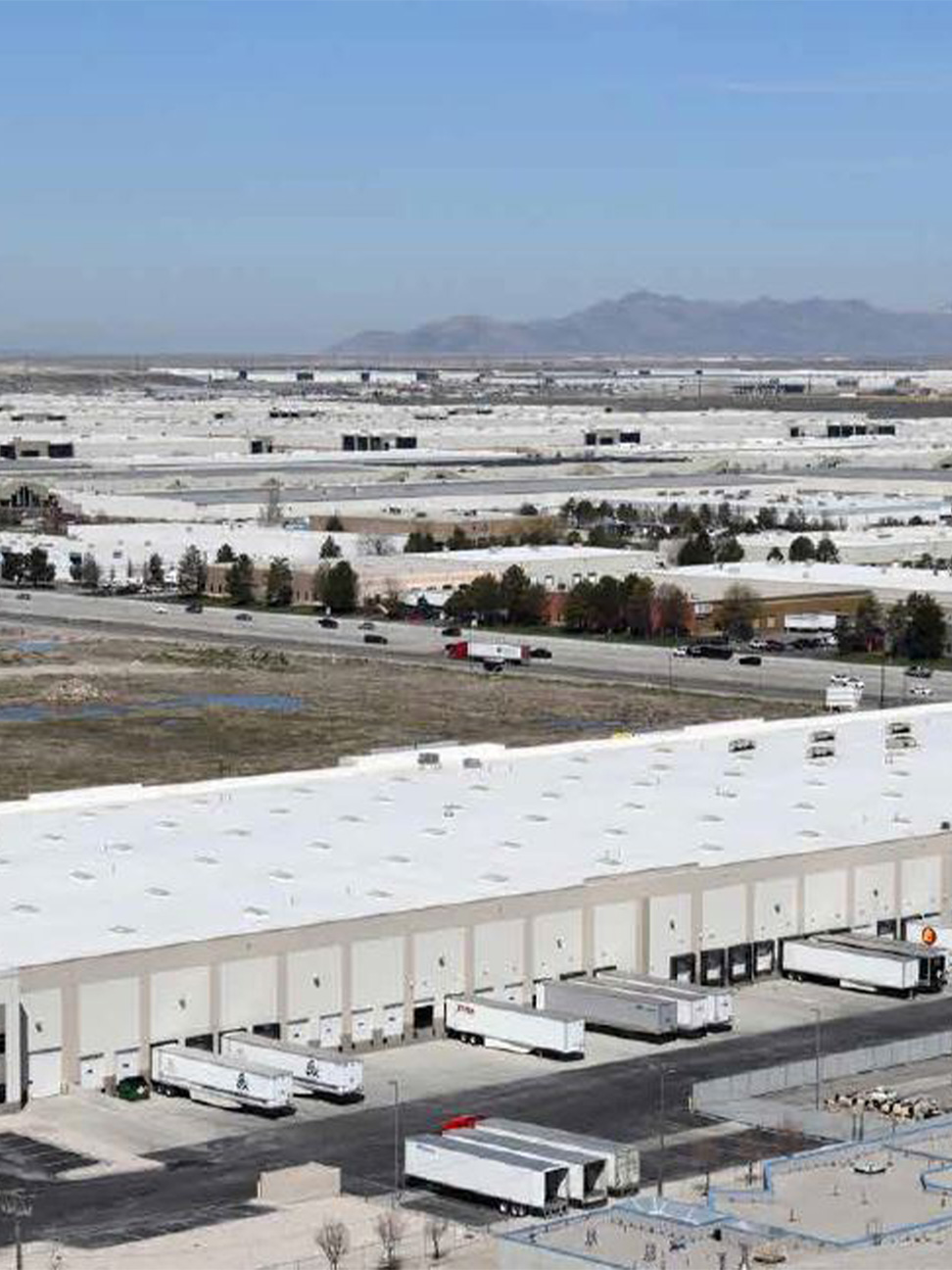 Aerial view of distribution facility with trailers parked in docks