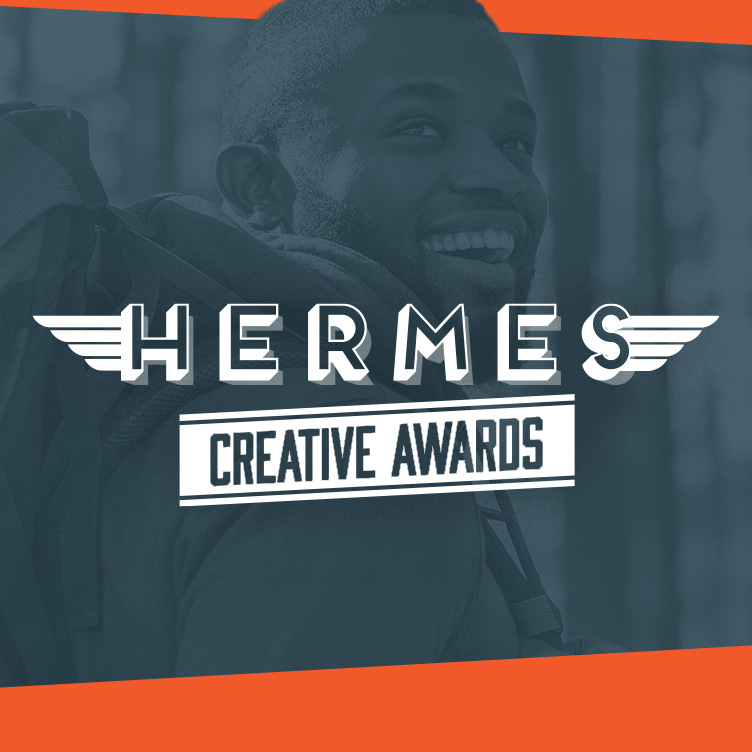 Hermes Creative Awards logo with smiling person.