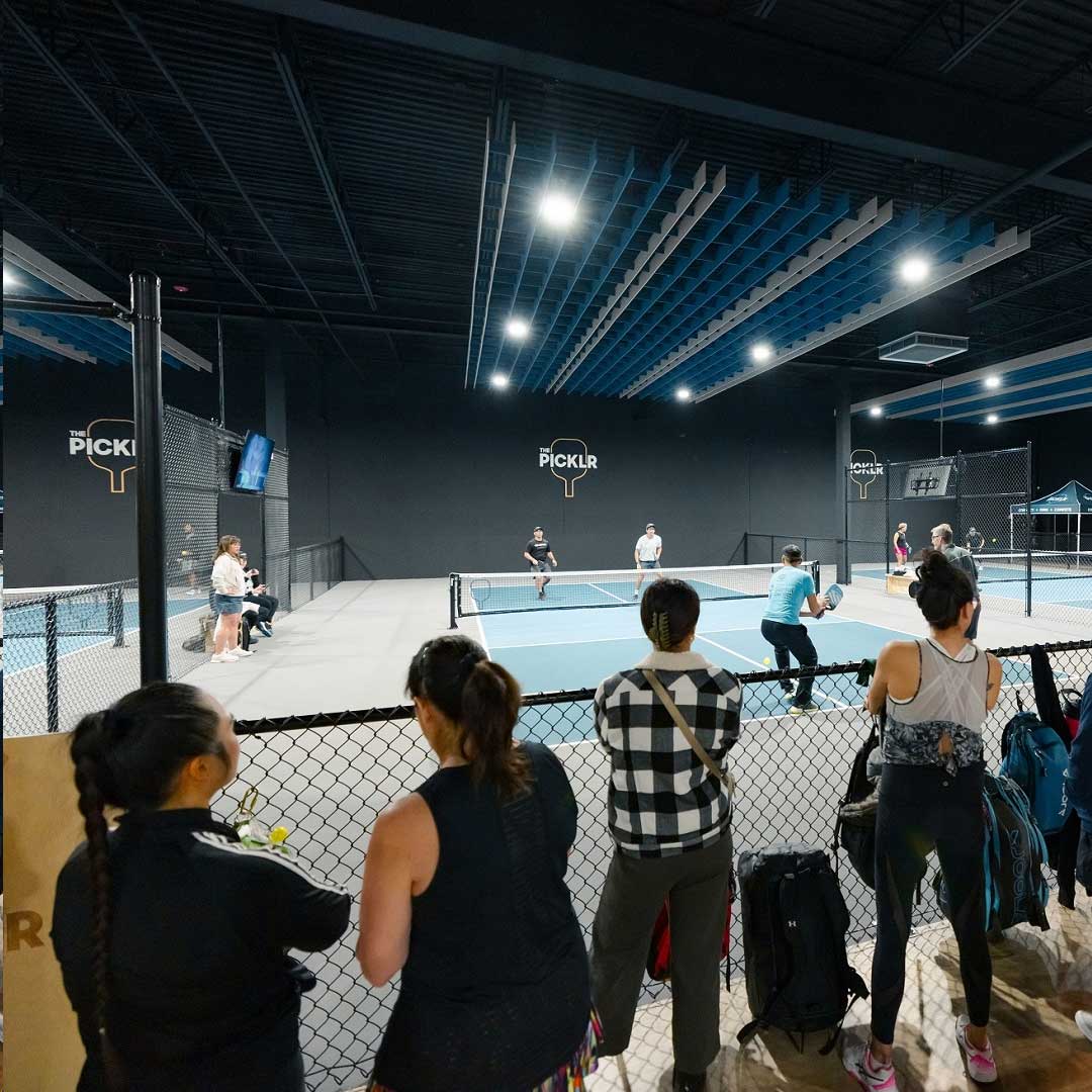 Interior shot of people playing pickleball at The Picklr.