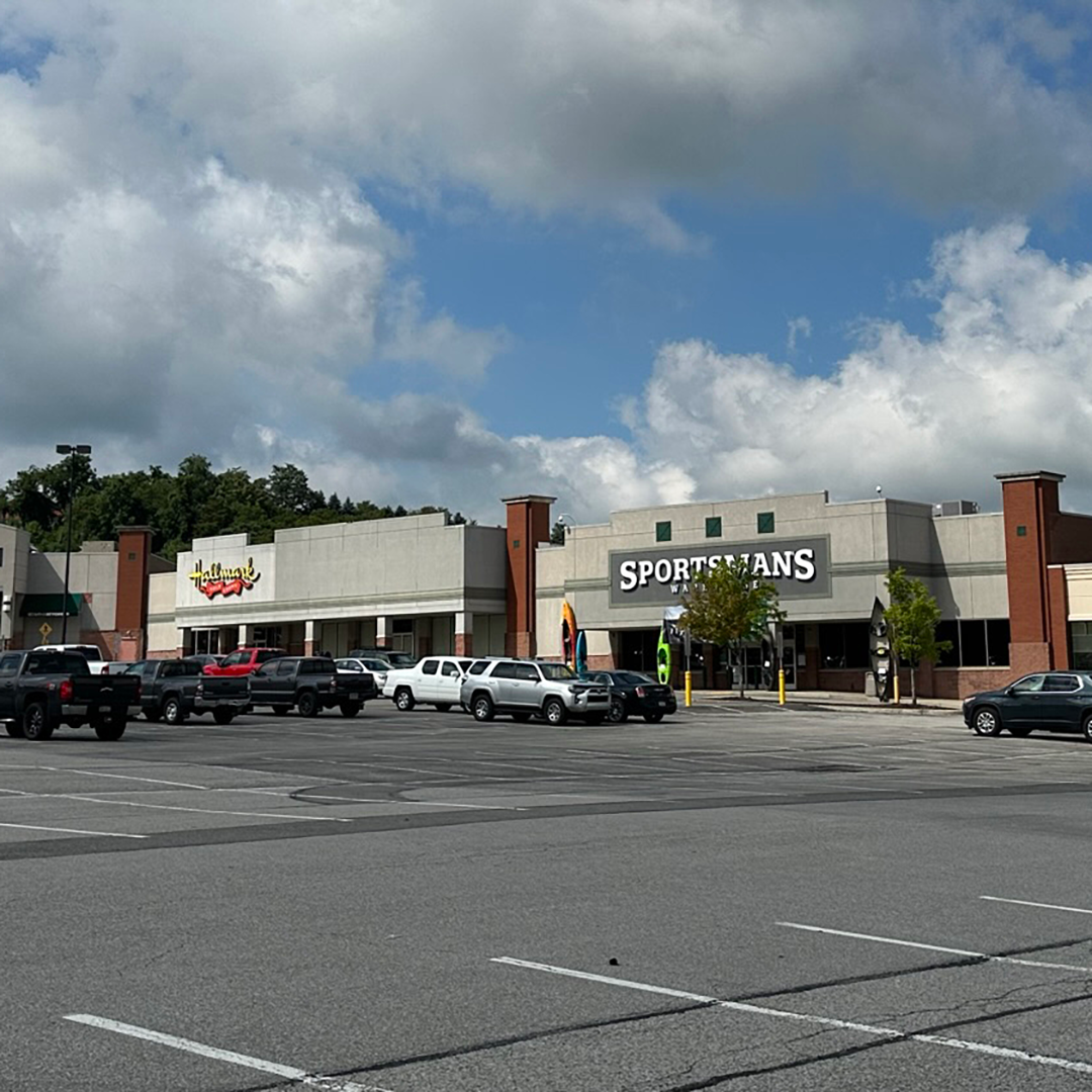 A parking lot in front of an outdoor retail center