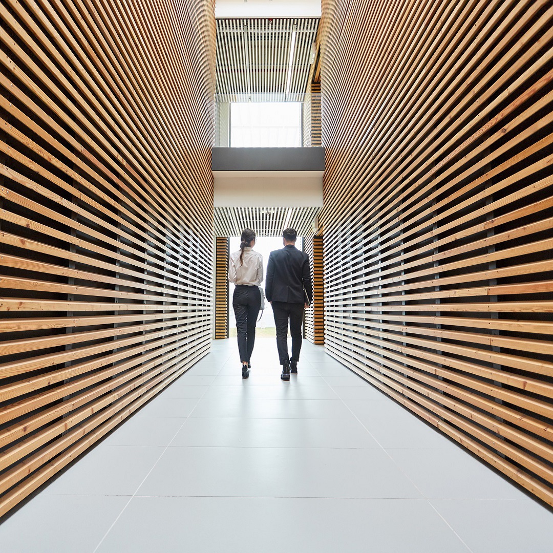 Colleagues walking through an office corridor