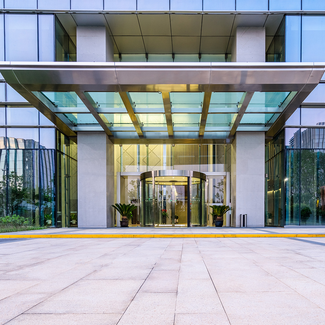 Exterior of hotel entrance with revolving door to lobby