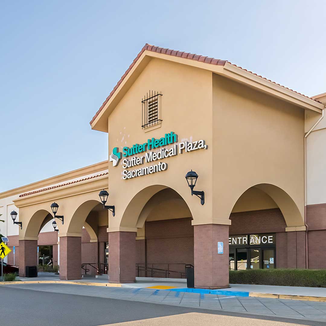 Exterior of Sutter Health, a tan building with arches.