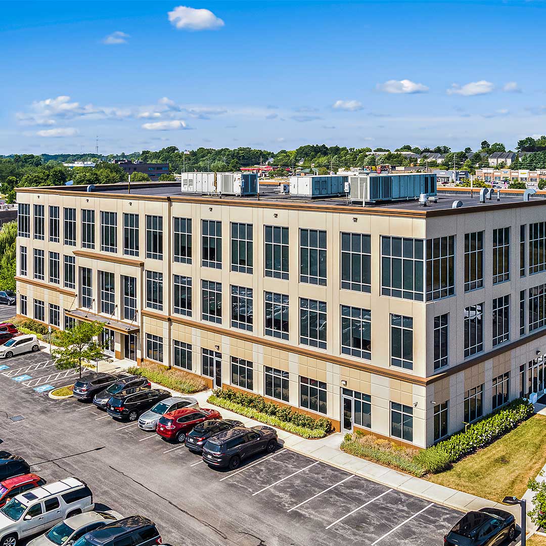 Exterior of Medical Office Building in Baltimore, Maryland with cars in the parking lot on a sunny day