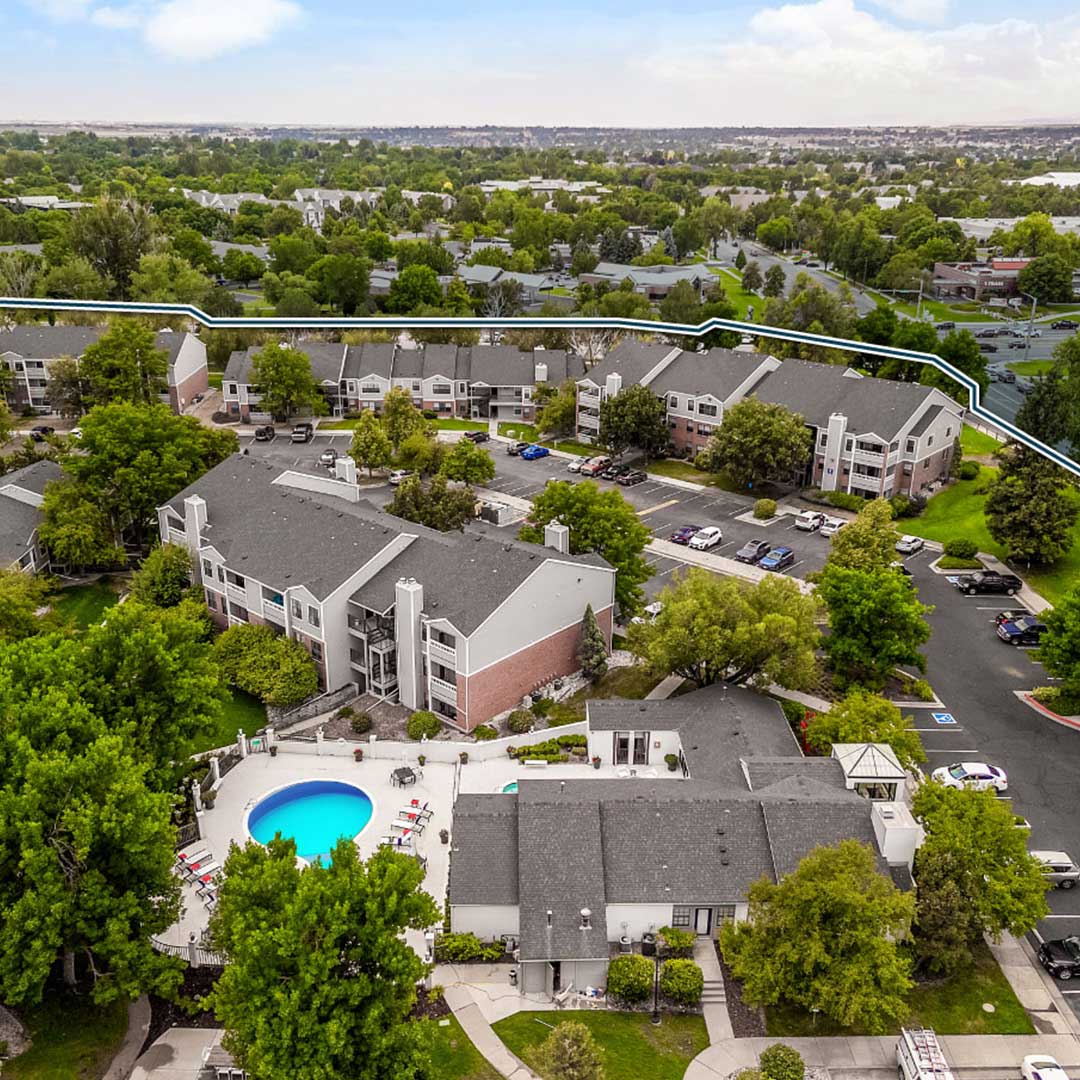 Ariel view of Courtney Park apartment community in Fort Collins Colorado with multiple buildings with a pool and parking lot