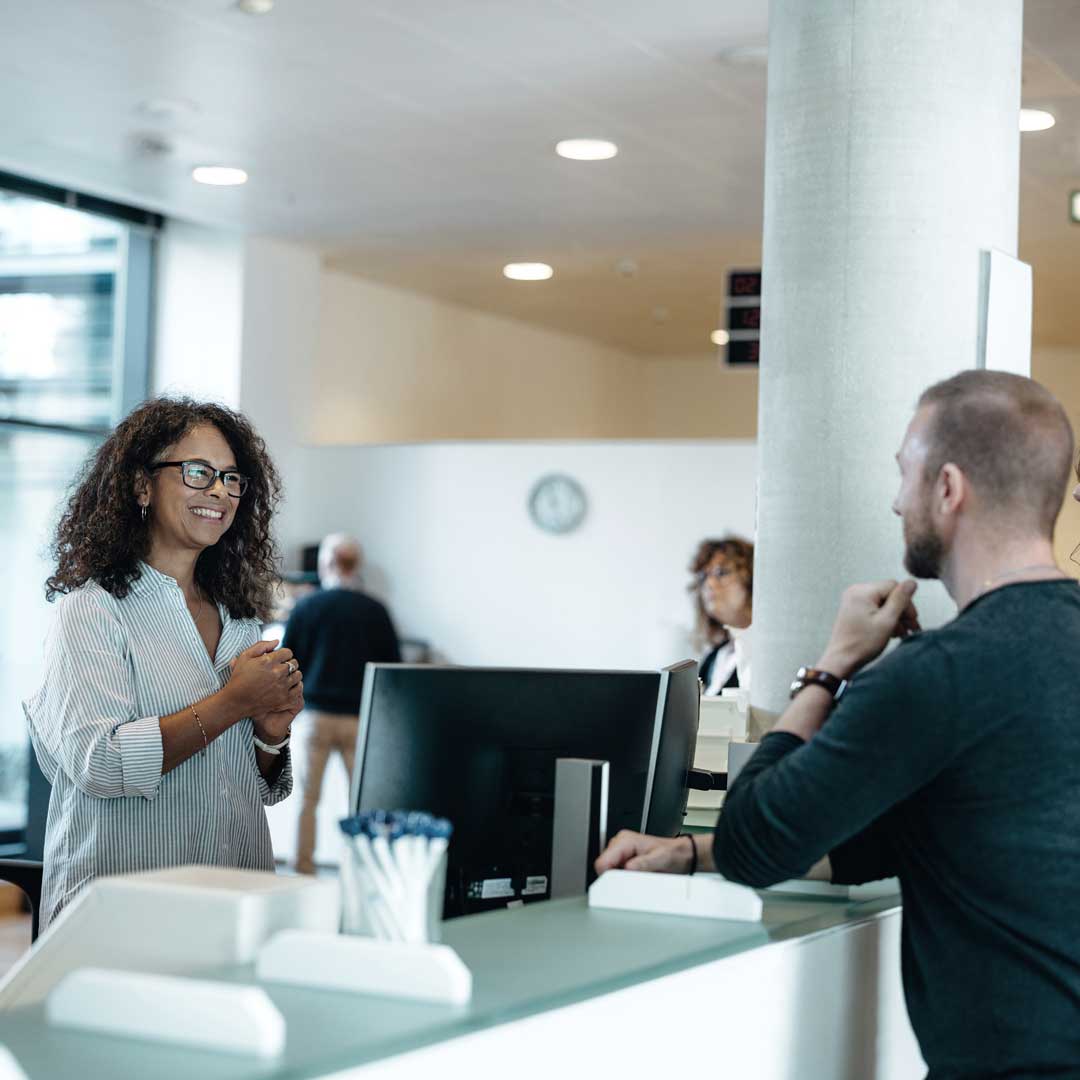 Woman and man at hotel check-in counter
