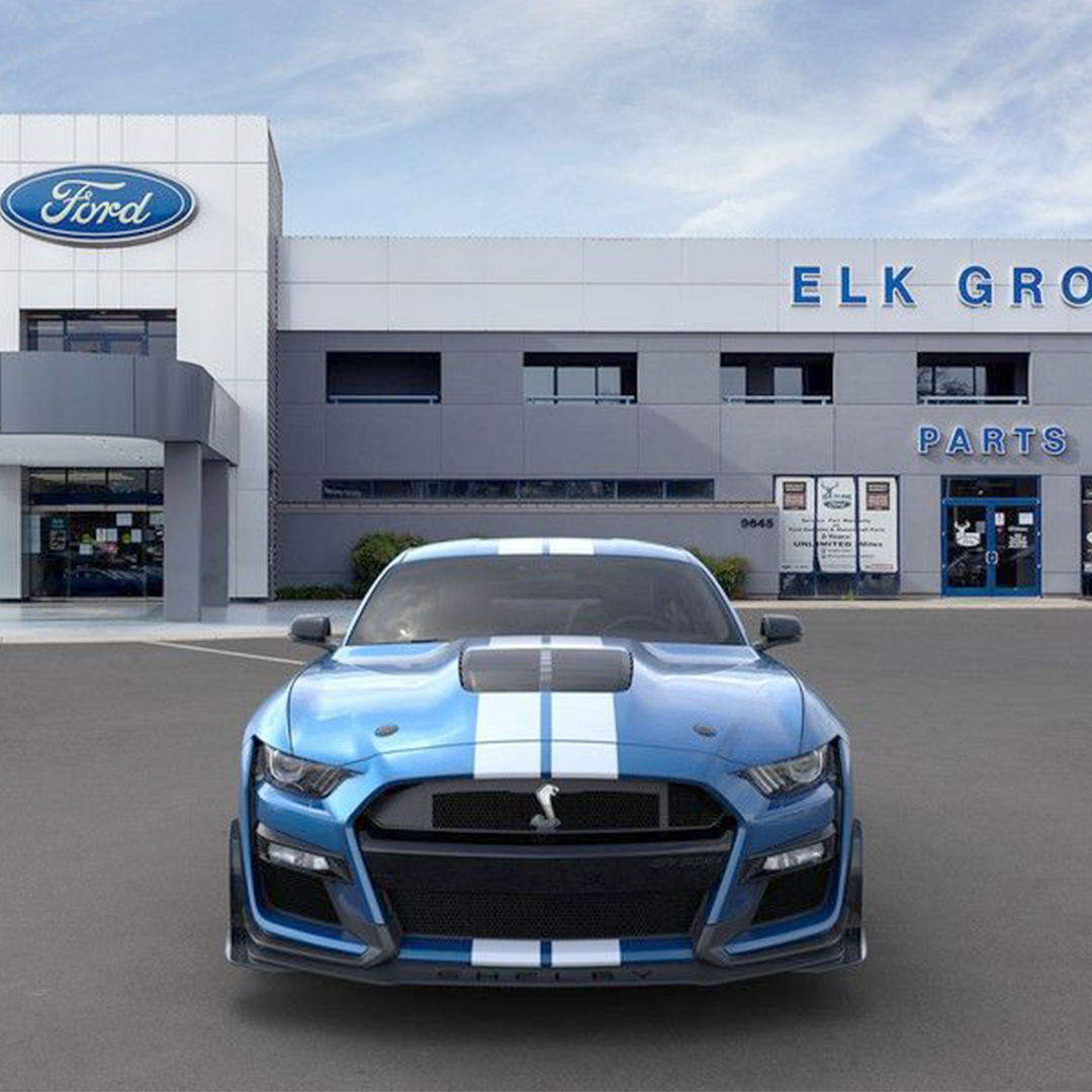 Exterior of Elk Grove Ford with a blue Ford Mustang Cobra parked in front