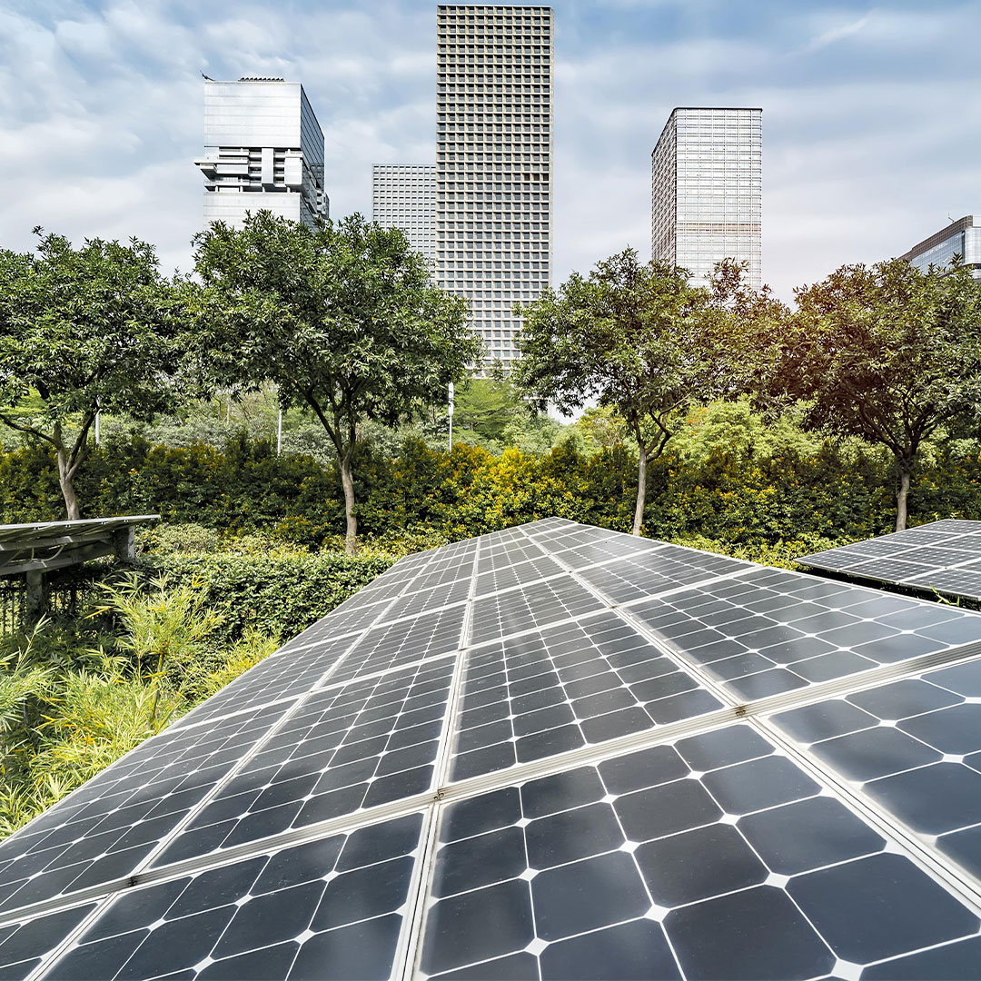 Urban landscape with renewable energy solar panels, promoting CBRE's sustainable energy solutions.